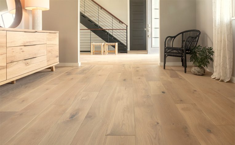 warm toned hardwood flooring in hallway.