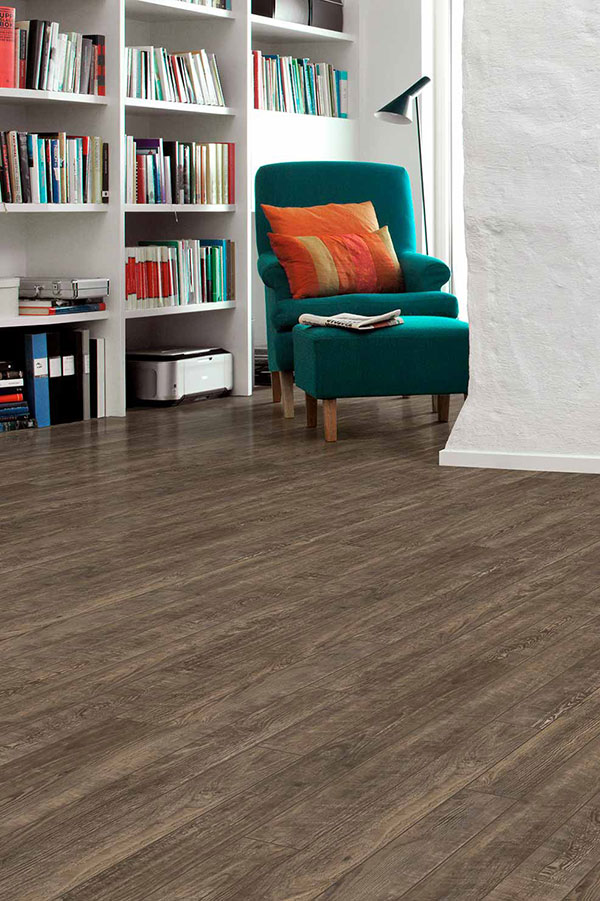 Dark green accent chair on wooden floor