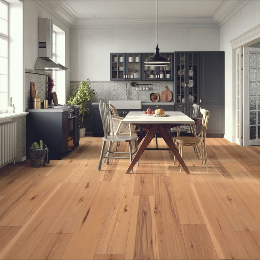 light hardwood flooring in a Knoxville kitchen with dark cabinets and dining table